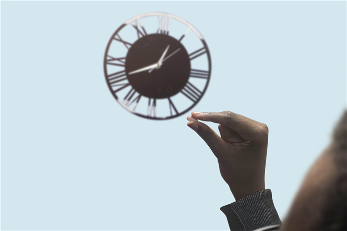 A man holding a tadalafil tablet looking at the clock