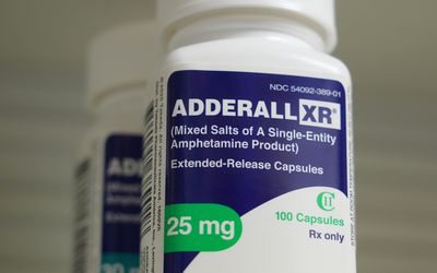 A close-up of 25-milligram Adderall XR prescription pill bottle 